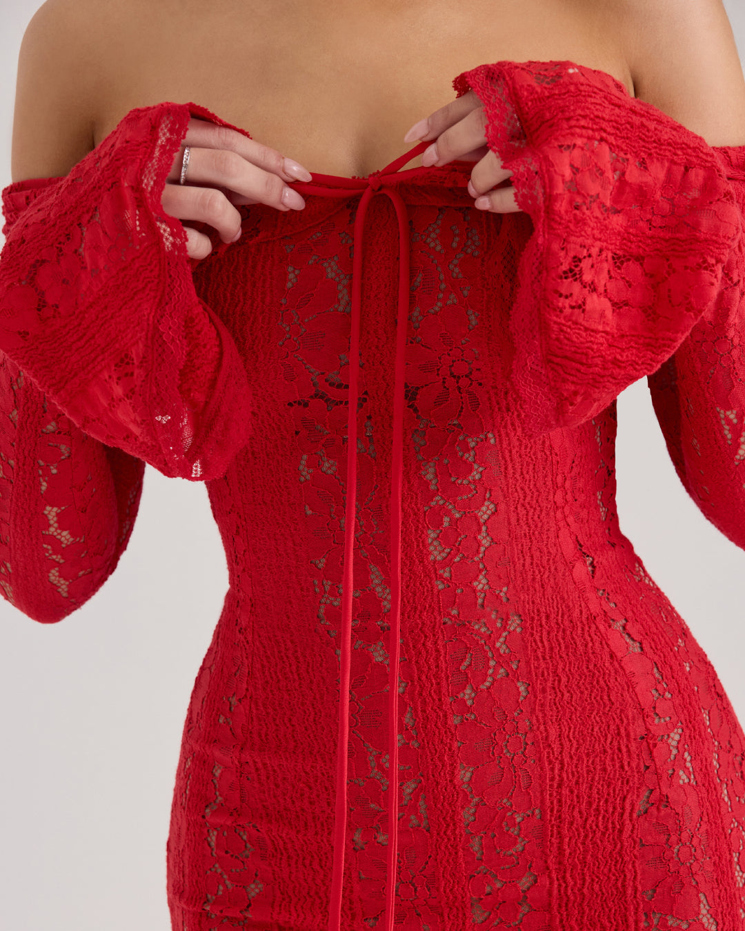 Close-up of lace detail on Lettie red wedding guest dress