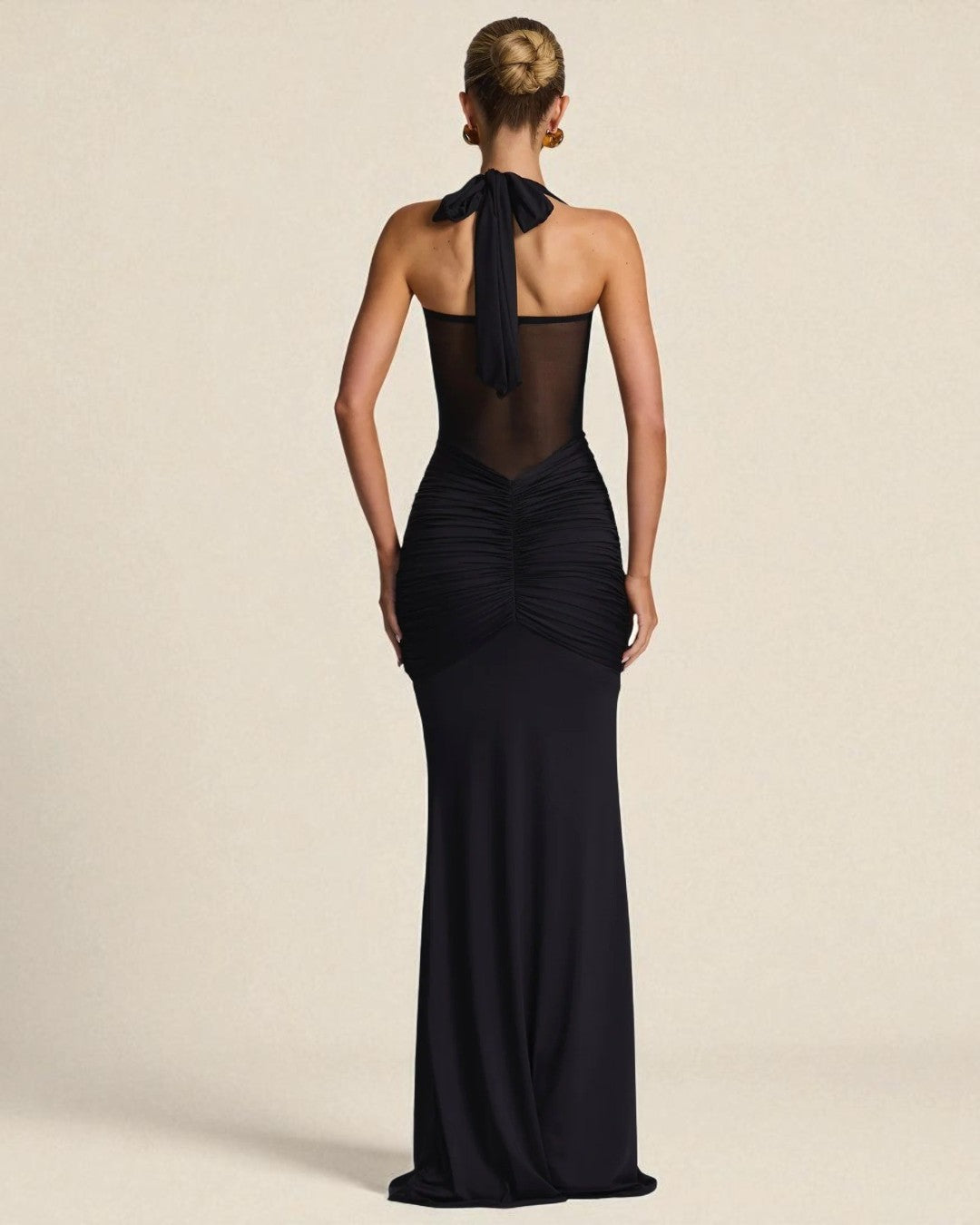 Back view of Lucy black halter neck bridesmaid gown with fitted design