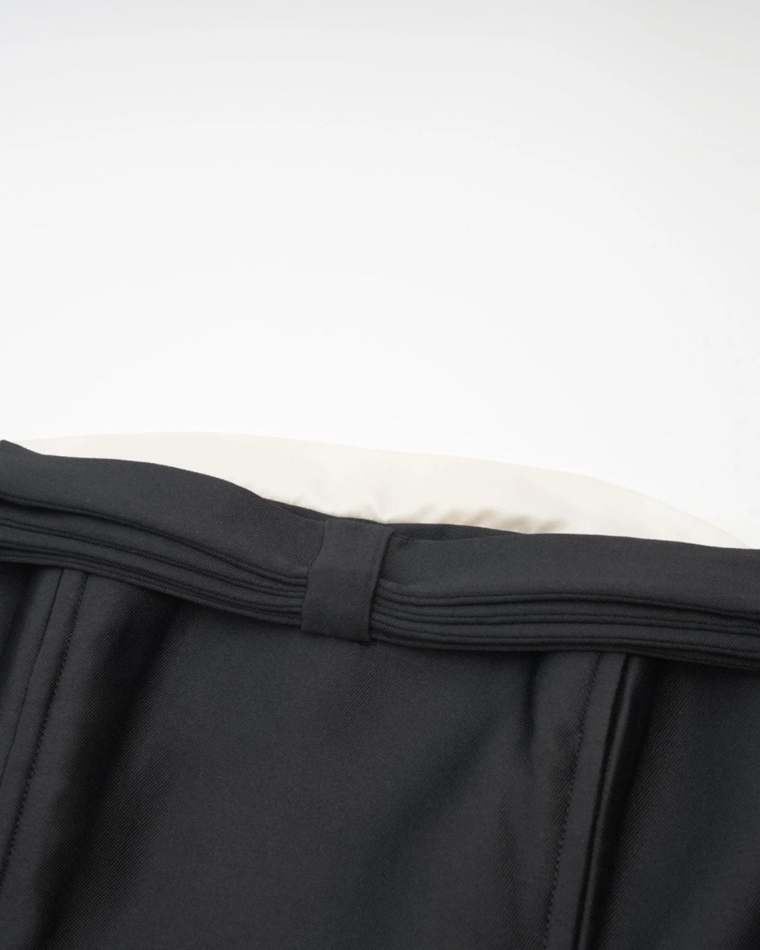 Close-up of a black strapless garment of lydia midi dress in black, perfect for old money look.