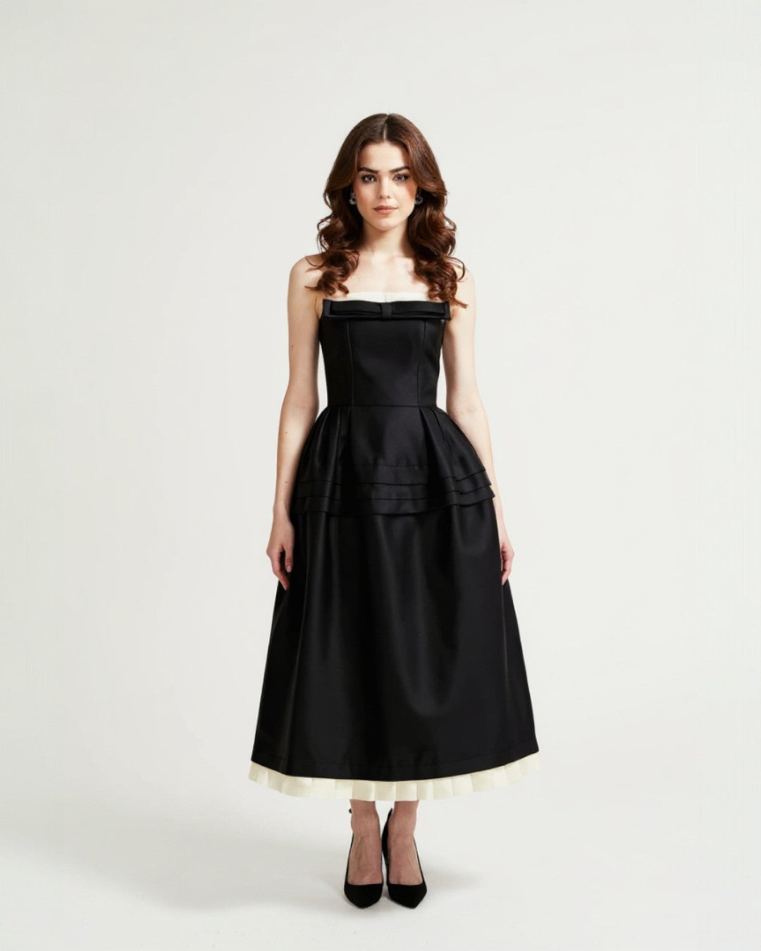 Woman wearing a black strapless dress with a white hem