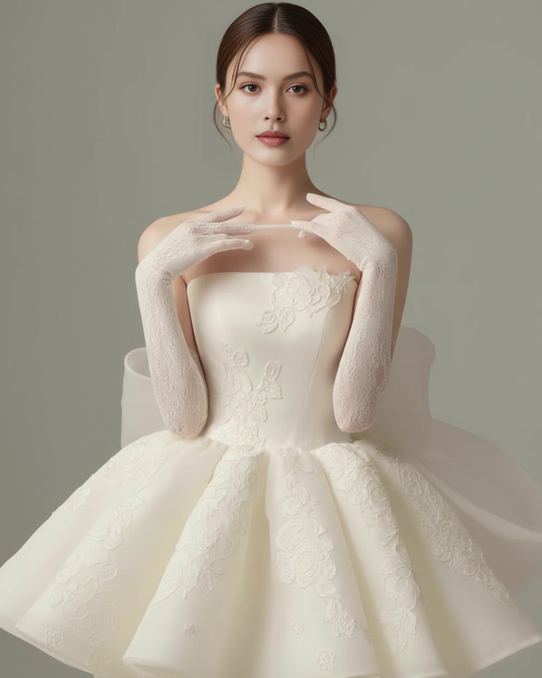 Bride wearing an elegant mini wedding dress with embroidered fabric and a long bow-tie tulle bridal veil at the back, approximately 2 meters long, dancing gracefully on a floral stage.
