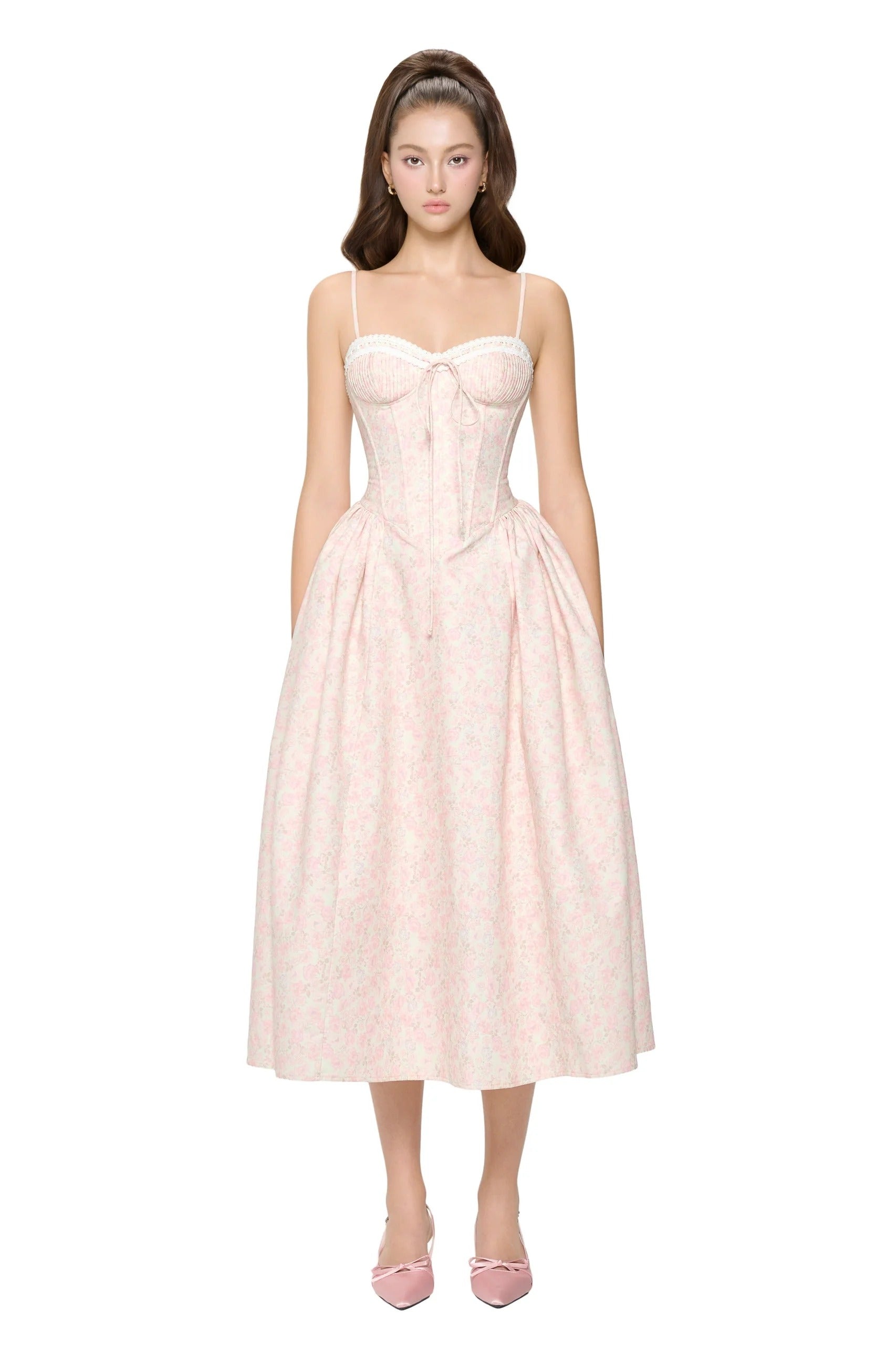 A woman wearing a formal floral pastel midi dress walking gracefully at an outdoor graduation ceremony, showcasing the elegant floral details and flattering fit.