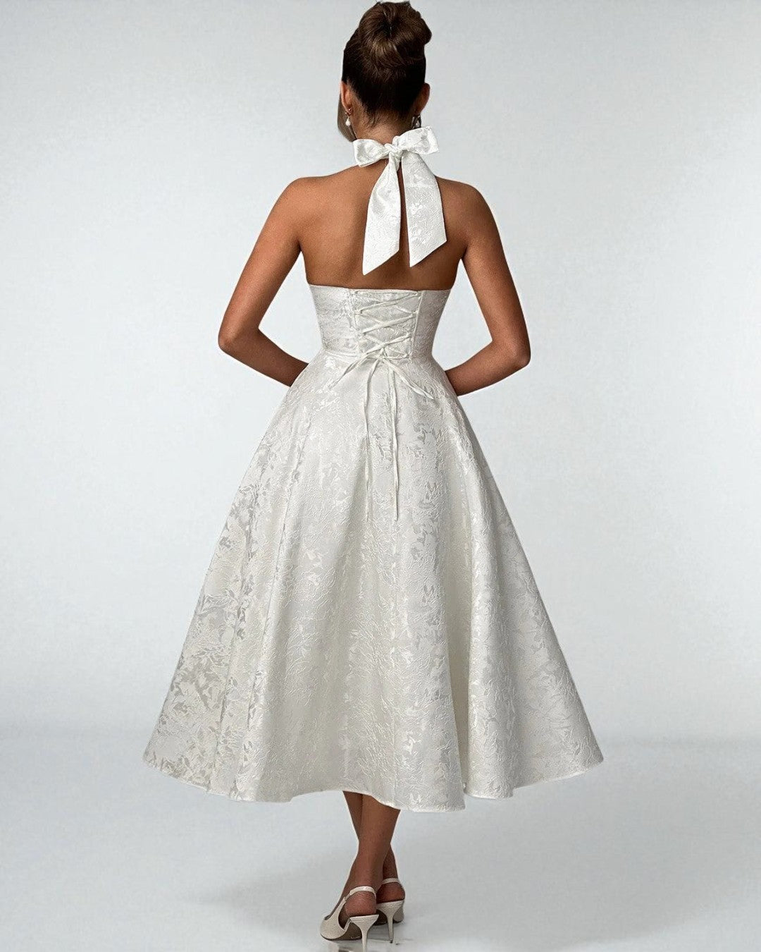 Back view of Sadie white satin halter midi dress